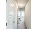 Neutral hallway featuring a carpeted floor and views into the bedrooms at the end of the hall at 2142 Theberton Trl, Locust Grove, GA 30248