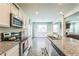 Gourmet kitchen features granite countertops, stainless steel appliances, and a seamless flow into the living space at 2142 Theberton Trl, Locust Grove, GA 30248