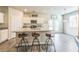 Bright kitchen with granite countertops, stainless steel appliances, and barstool seating at the island at 2142 Theberton Trl, Locust Grove, GA 30248