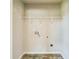 Unfinished laundry room with tile flooring, shelving, and washer and dryer hookups at 2142 Theberton Trl, Locust Grove, GA 30248