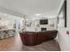 Open-concept living room with a fireplace, hardwood floors, and seamlessly connected to the adjacent kitchen at 2142 Theberton Trl, Locust Grove, GA 30248