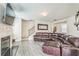 Comfortable living room featuring hardwood floors, a cozy fireplace, and a mounted flatscreen television at 2142 Theberton Trl, Locust Grove, GA 30248