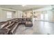 Spacious living room featuring hardwood floors and a large comfortable leather sectional sofa and an open concept at 2142 Theberton Trl, Locust Grove, GA 30248