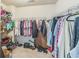 Walk-in closet featuring wire shelving, carpet flooring, and plenty of storage space at 2142 Theberton Trl, Locust Grove, GA 30248