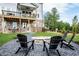 Inviting backyard with a stone fire pit surrounded by Adirondack chairs and a well-manicured lawn at 4725 Montane St, Cumming, GA 30028
