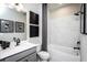 Modern bathroom showcasing a sleek vanity, framed mirrors, tub, and shower with stylish fixtures at 4725 Montane St, Cumming, GA 30028