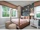 Elegant bedroom with a four-poster bed, animal themed wallpaper, and two large windows at 4725 Montane St, Cumming, GA 30028