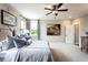 Comfortable bedroom features soft carpet, a ceiling fan, and a modern interior design at 4725 Montane St, Cumming, GA 30028