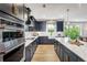 Well-equipped kitchen featuring dark cabinets, white countertops, stainless steel appliances, and an island at 4725 Montane St, Cumming, GA 30028