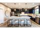 Elegant kitchen with a large island, dark cabinetry, pendant lighting and stainless steel appliances at 4725 Montane St, Cumming, GA 30028