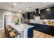 Modern kitchen with black cabinets, a quartz countertop island, and stainless steel appliances at 4725 Montane St, Cumming, GA 30028