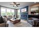 Cozy living room features a fireplace, ceiling fan, and ample natural light at 4725 Montane St, Cumming, GA 30028