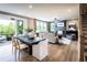 Bright open-concept living room with a fireplace, deck, and dining area offers modern living space at 4725 Montane St, Cumming, GA 30028
