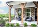 Inviting front porch with timber posts, outdoor seating, and manicured landscaping at 4725 Montane St, Cumming, GA 30028