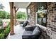 Cozy front porch with modern chairs and a table, providing a relaxing outdoor space at 4725 Montane St, Cumming, GA 30028