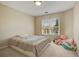 Bedroom with plush carpet, a neutral color scheme, and a sunny window view at 5177 Cabot Creek Dr, Buford, GA 30518