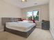 This well-lit bedroom features a ceiling fan and a large window to let in natural light at 5177 Cabot Creek Dr, Buford, GA 30518