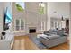Spacious living room with soaring ceilings, a fireplace, and large windows at 5177 Cabot Creek Dr, Buford, GA 30518