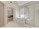 Bright main bath featuring a soaking tub and glass-enclosed shower at 5177 Cabot Creek Dr, Buford, GA 30518
