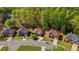 An aerial view showcases the charming neighborhood nestled amongst lush trees in the community at 660 Gran Heritage Way, Dacula, GA 30019