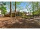A spacious backyard features mature trees, lush landscaping, and tiered garden beds at 660 Gran Heritage Way, Dacula, GA 30019