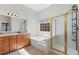 Bathroom featuring a glass shower, a bathtub, and dual sink vanity at 660 Gran Heritage Way, Dacula, GA 30019