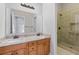 Bright bathroom featuring a double vanity, granite counters, and glass-enclosed shower at 660 Gran Heritage Way, Dacula, GA 30019