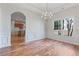 Formal dining area with hardwood floors, tray ceiling, chandelier, and views to the kitchen at 660 Gran Heritage Way, Dacula, GA 30019