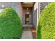 A welcoming front entrance features a brick facade, a covered porch, and lush landscaping at 660 Gran Heritage Way, Dacula, GA 30019