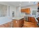 Modern kitchen featuring an island, granite countertops, tile backsplash, stainless steel appliances, and a view to the backyard at 660 Gran Heritage Way, Dacula, GA 30019