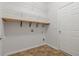 Functional laundry room with storage shelves, vinyl flooring, and a white door at 660 Gran Heritage Way, Dacula, GA 30019