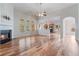 An open-concept living area showcases hardwood floors, a fireplace, and access to the kitchen at 660 Gran Heritage Way, Dacula, GA 30019