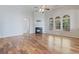 A spacious living area boasts hardwood floors, a cozy fireplace, and ample natural light through large windows at 660 Gran Heritage Way, Dacula, GA 30019