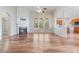 A spacious living room features hardwood floors, fireplace, and large windows that provide natural light at 660 Gran Heritage Way, Dacula, GA 30019
