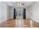 Main bedroom with tray ceiling, wood floors, large window, and French doors at 660 Gran Heritage Way, Dacula, GA 30019