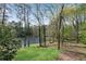 Spacious backyard with mature trees and serene lake views at 9055 Carroll Manor Dr, Sandy Springs, GA 30350
