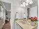 Bathroom featuring a marble countertop, decorative flowers, and updated fixtures at 9055 Carroll Manor Dr, Sandy Springs, GA 30350