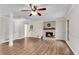 Inviting living room featuring a cozy fireplace, ceiling fan, and updated flooring at 9055 Carroll Manor Dr, Sandy Springs, GA 30350