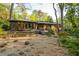 Expansive backyard featuring a gravel ground cover, brick and siding home exterior, and extensive landscaping at 1850 Winchester Trl, Brookhaven, GA 30341