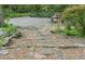 Backyard garden with stone steps leading to a serene outdoor seating area and lush plantings at 1850 Winchester Trl, Brookhaven, GA 30341