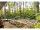 Extensive backyard features a gravel ground cover, lush landscaping, a small water feature, and mature trees for privacy at 1850 Winchester Trl, Brookhaven, GA 30341