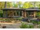 Exterior of home with brick and dark trim featuring a deck with furniture and decorative landscaping at 1850 Winchester Trl, Brookhaven, GA 30341