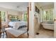 Spacious main bedroom featuring hardwood floors and a full bathroom suite with a clawfoot tub and natural light at 1850 Winchester Trl, Brookhaven, GA 30341