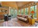 Inviting sunroom with exposed brick, multiple windows offering great views, and comfortable seating for relaxing at 1850 Winchester Trl, Brookhaven, GA 30341