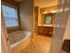Bathroom featuring a jetted tub, double vanity, and a separate glass-enclosed shower at 445 Pintail Ct, Suwanee, GA 30024