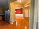 Inviting foyer with hardwood floors, leading to the kitchen with stainless steel appliances and a dining room with red walls at 445 Pintail Ct, Suwanee, GA 30024