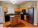 Kitchen with hardwood floors, stainless steel appliances, kitchen island and lots of light at 445 Pintail Ct, Suwanee, GA 30024