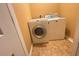 Compact laundry area featuring a front load washing machine and dryer at 445 Pintail Ct, Suwanee, GA 30024