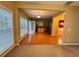 Living room with hardwood floors and lots of light looking into kitchen and additional room at 445 Pintail Ct, Suwanee, GA 30024