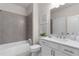 Well-lit bathroom with a shower and tub combo, and modern fixtures at 627 Skytop Dr, Cumming, GA 30040